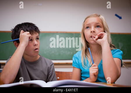 Thoughtful children working together Stock Photo