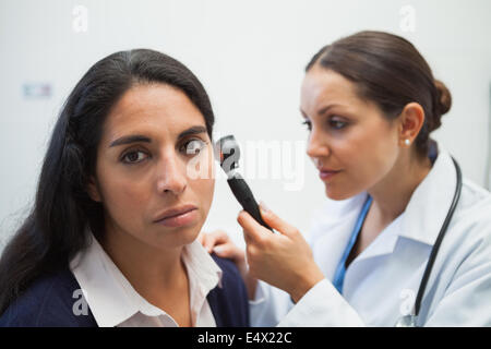 Patients ear being checked by doctor Stock Photo