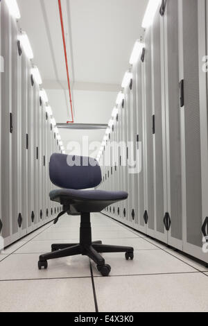 Chair in empty row of servers Stock Photo
