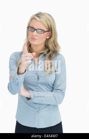 Blonde with glasses pointing Stock Photo