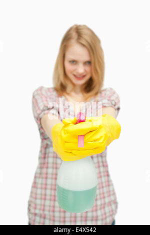 fair-haired woman holding a spray bottle Stock Photo