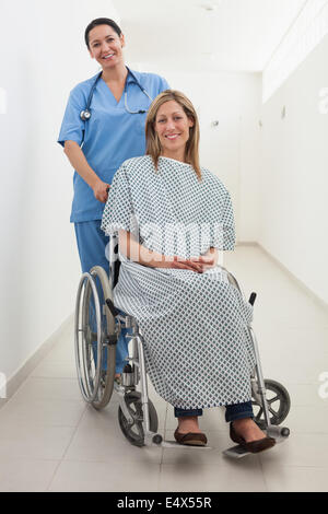Happy nurse and patient in wheelchair Stock Photo