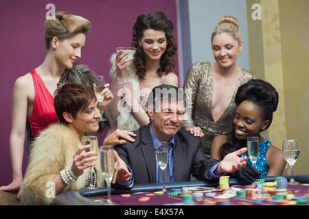 Man and women sitting at the table playing Stock Photo