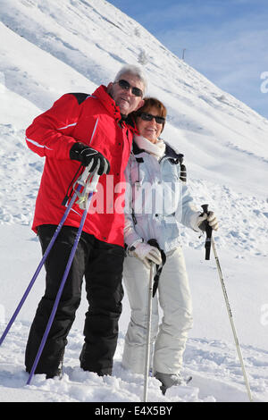 Senior couple walking in the snow Stock Photo