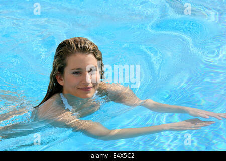 Young woman swimming in a pool Stock Photo