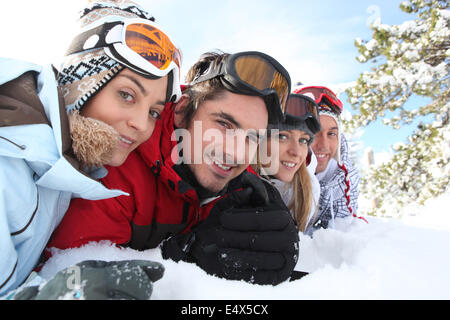 Ski couples lying in the snow Stock Photo