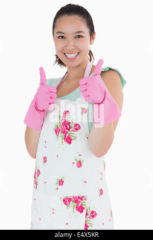 Woman wearing rubber gloves giving thumbs up Stock Photo