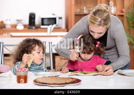 kids eating pancakes for breakfast Stock Photo