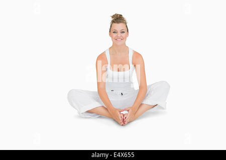 Woman sitting in bound angle yoga pose Stock Photo