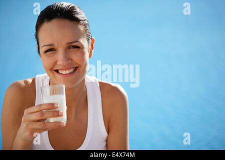 Healthy woman drinking a glass of milk Stock Photo