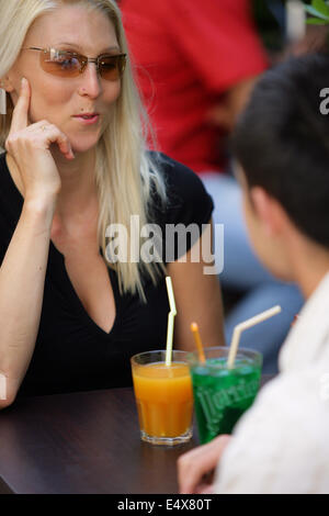 Couple having a drink on a terrace Stock Photo