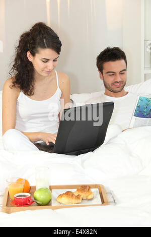 Couple having breakfast in bed Stock Photo