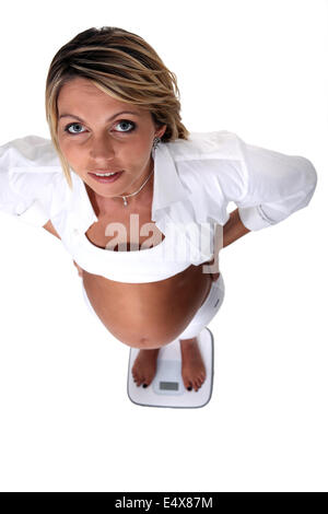 Pregnant woman on scales Stock Photo