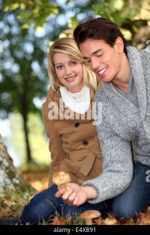 Couple picking mushrooms together Stock Photo
