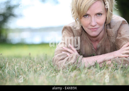 woman lying on the grass Stock Photo