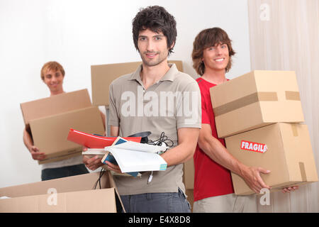 House mates carrying boxes Stock Photo