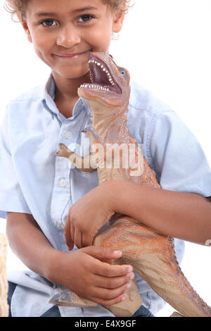 Little boy playing with toy dinosaur Stock Photo