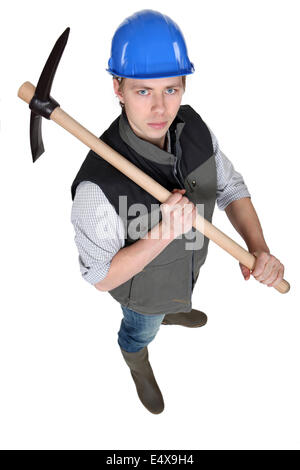 Tradesman holding a pickaxe Stock Photo