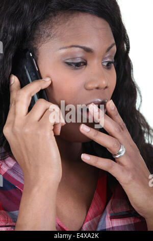 Woman in shock on a cellphone Stock Photo