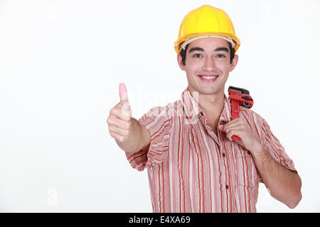 Thumbs up from a young construction worker Stock Photo