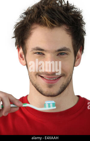 Young man holding a toothbrush Stock Photo