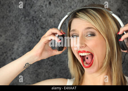 Woman having fun singing loudly Stock Photo