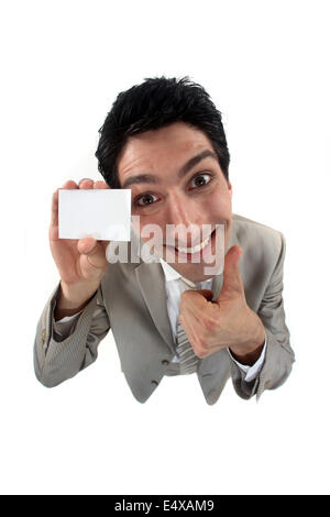 Grinning man holding up his business card Stock Photo