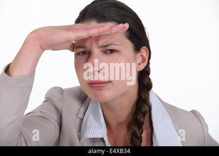 Brunette businesswoman saluting Stock Photo