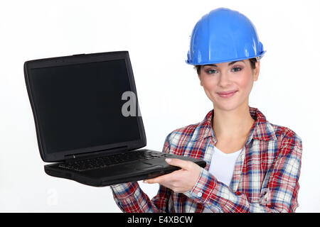 Female contractor holding laptop Stock Photo