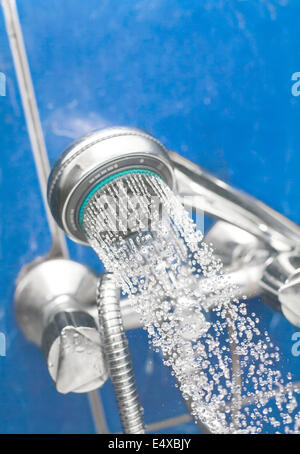 a shower head is spraying water. Stock Photo