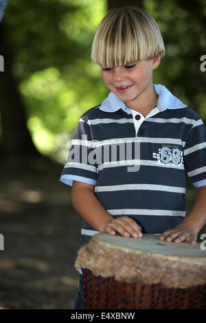 Boy playing African drum Stock Photo