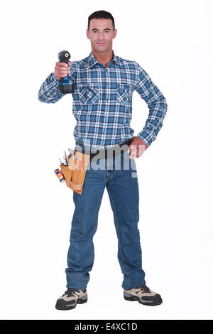 Tradesman aiming his power tool Stock Photo