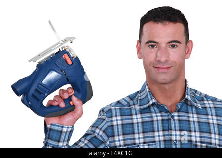 Man holding band-saw Stock Photo