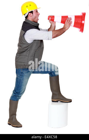 Young man screaming in a traffic cone Stock Photo