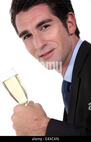 Businessman holding champagne flute Stock Photo
