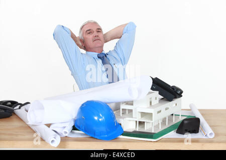 Architect sat at desk Stock Photo