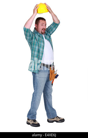 Construction worker putting on a helmet Stock Photo