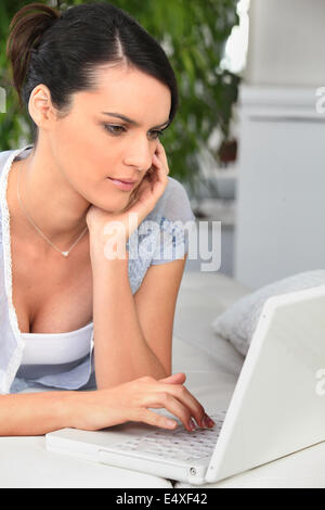 Woman studying at home on the sofa Stock Photo