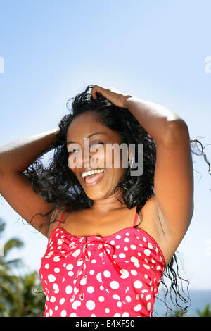 Excited woman stood in the garden Stock Photo