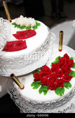 Decorated wedding cake with red roses Stock Photo