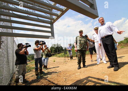Golqm Dervent, Bulgaria. 17th July, 2014. Bulgarian Defense Minister Angel Naidenov speaks to the Press as Bulgarian Borger police officers attend near newly build 30 kms long border fence at Bulgarian-Turkey border, as they present it to the press Thursday, July, 17, 2014. The wave of refugees flocking to Bulgaria has been growing again over the past few weeks. Bulgaria builded the fence on its border with Turkey to end illegal border crossings into the country. Credit:  ZUMA Press, Inc./Alamy Live News
