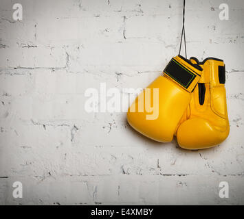 Pair of boxing gloves hanging on a wall Stock Photo