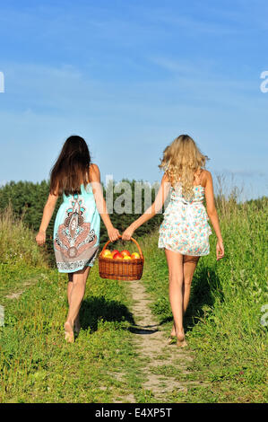 https://l450v.alamy.com/450v/e4xp5t/two-beautiful-women-walking-at-the-meadow-e4xp5t.jpg