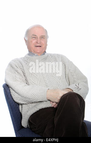 Happy senior man relaxing in a chair Stock Photo