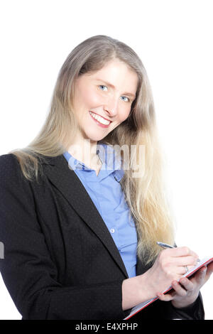 Smiling businesswoman writing notes Stock Photo