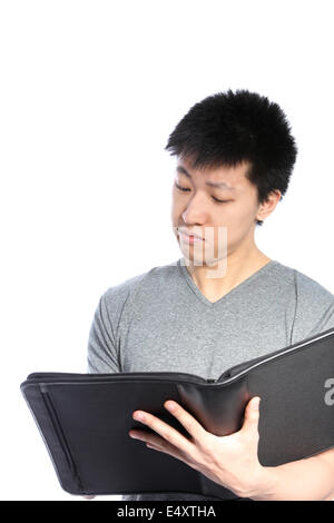 Casual Asian Man Looking Inside Binder Stock Photo