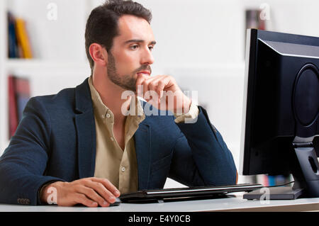Man Looking At A Computer Monitor Stock Photo