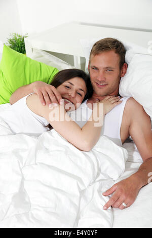 Loving couple resting in bed Stock Photo