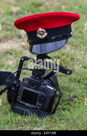 A Royal Military Police peaked cap, from a Military Police dress uniform, resting on a Nikon D800 camera. Stock Photo