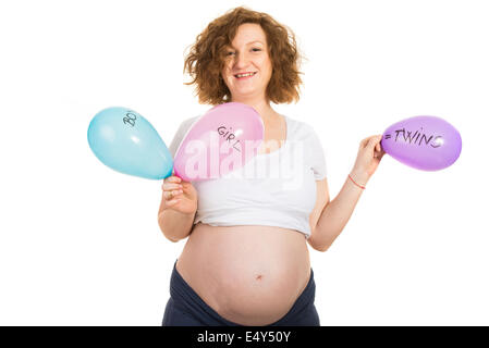 Happy pregnant waiting twins and holding balloons with this message isolated on white background Stock Photo